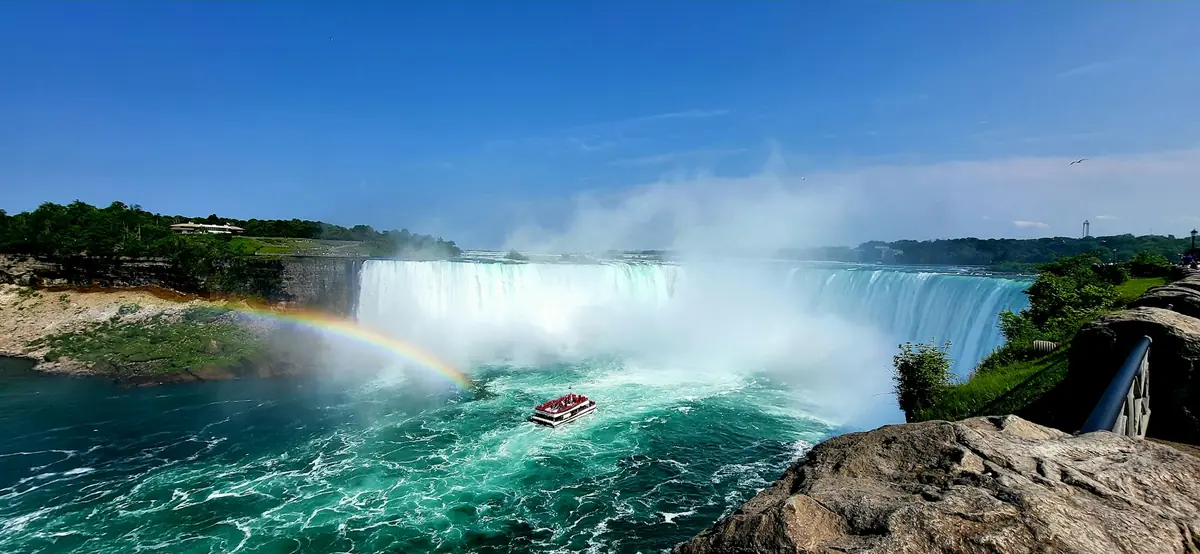 Tour boat and a rainbow below the Horseshoe Falls